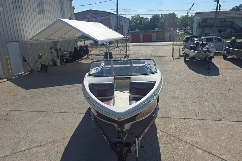 Slide: The Image of 2016 Tahoe 500 TS boat parked outdoors in a sunny dealership lot. - 3