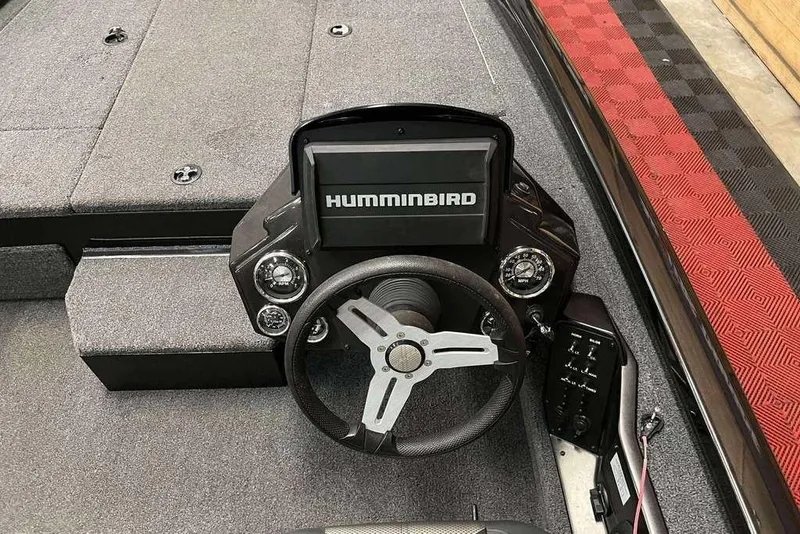 Slide: The Image of 2020 Vexus AVX1880 boat dashboard with Humminbird display and steering wheel. - 2