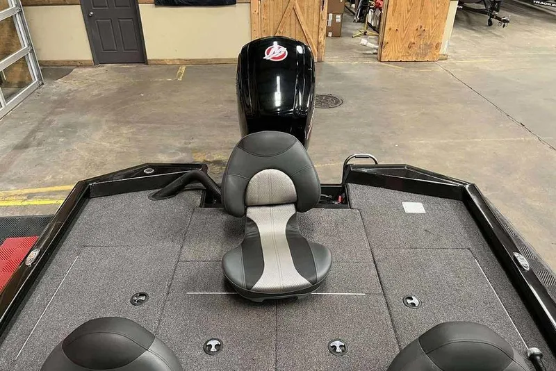 Slide: The Image of 2020 Vexus AVX1880 boat interior with seating and motor in a garage setting. - 3