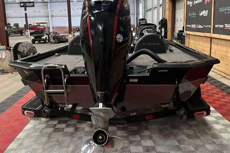 Slide: The Image of 2020 Vexus AVX1880 boat in showroom, rear view with motor and ladder. - 5