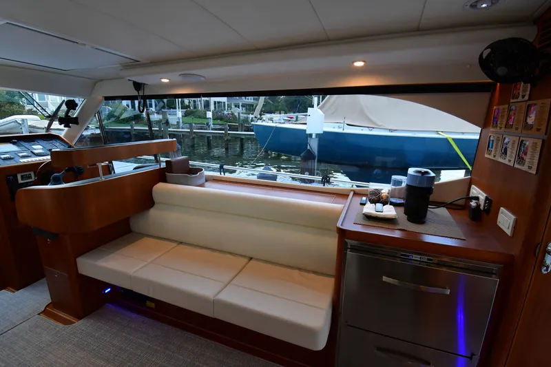 Slide: The Image of Interior of 2021 Hylas M44 yacht with seating, kitchenette, and marina view. - 13