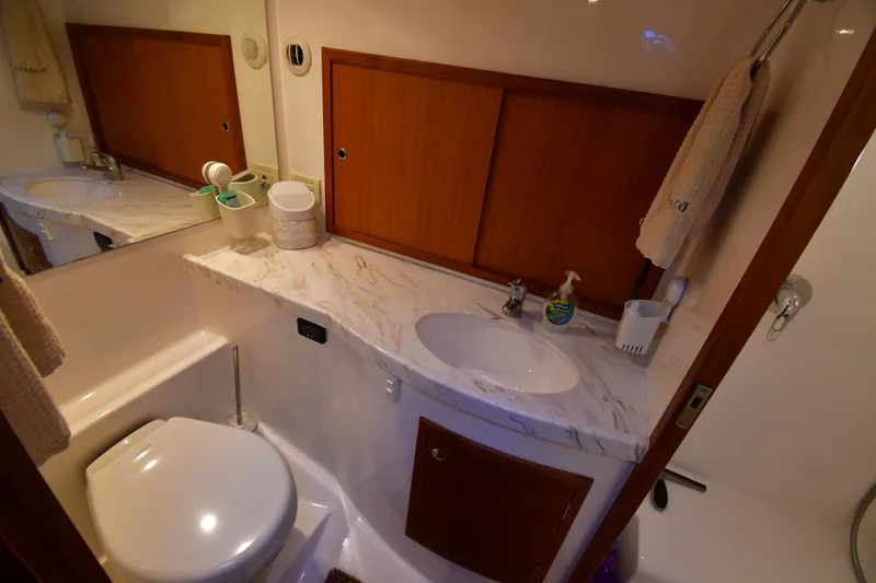 Slide: The Image of Luxurious bathroom in 2021 Hylas M44 yacht with marble countertop and wooden cabinetry. - 19