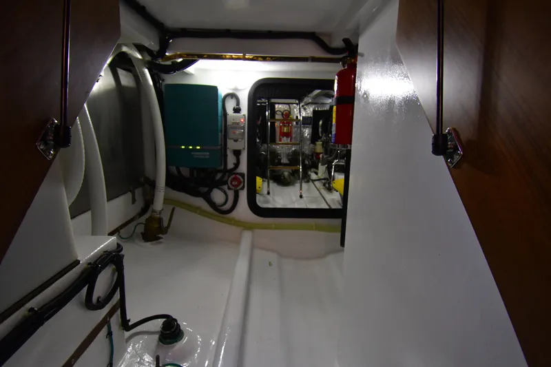 Slide: The Image of Engine room of 2021 Hylas M44 yacht, featuring equipment and storage space. - 27