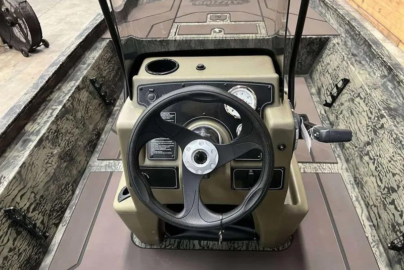 Slide: The Image of 2026 Tracker Grizzly 1860 CC boat console with steering wheel and gauges. - 6