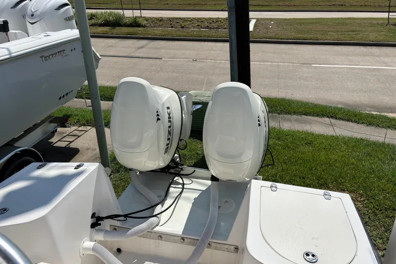 Slide: The Image of 1998 Mako 221 Center Console with dual Suzuki outboard motors, parked on a trailer. - 11