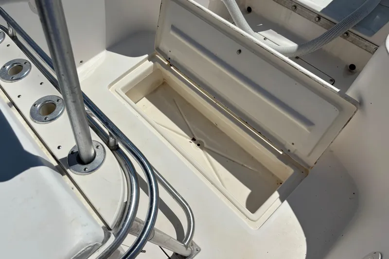 Slide: The Image of Open storage compartment on 1998 Mako 221 Center Console boat deck. - 12