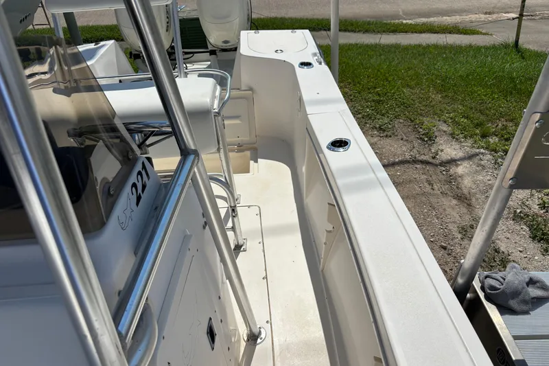 Slide: The Image of 1998 Mako 221 Center Console boat interior with seating and console details. - 13