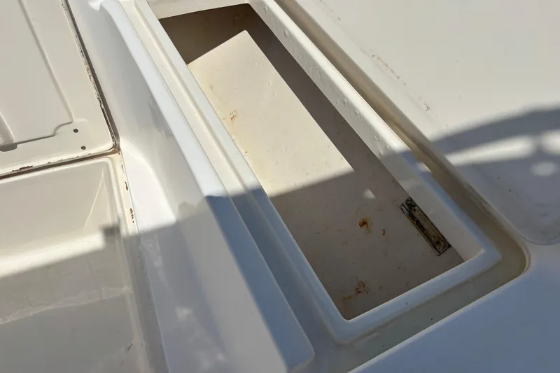 Slide: The Image of Open storage compartment on a 1998 Mako 221 Center Console boat. - 14