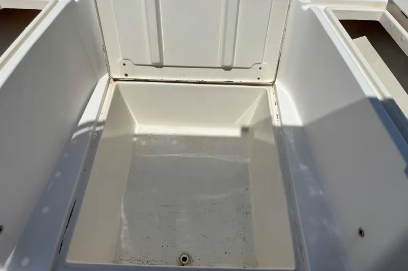 Slide: The Image of Open storage compartment on a 1998 Mako 221 Center Console boat. - 15