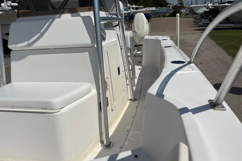 Slide: The Image of 1998 Mako 221 Center Console boat interior with seating and storage compartments. - 3
