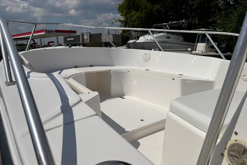Slide: The Image of 1998 Mako 221 Center Console boat interior with seating, parked near Exxon station. - 4