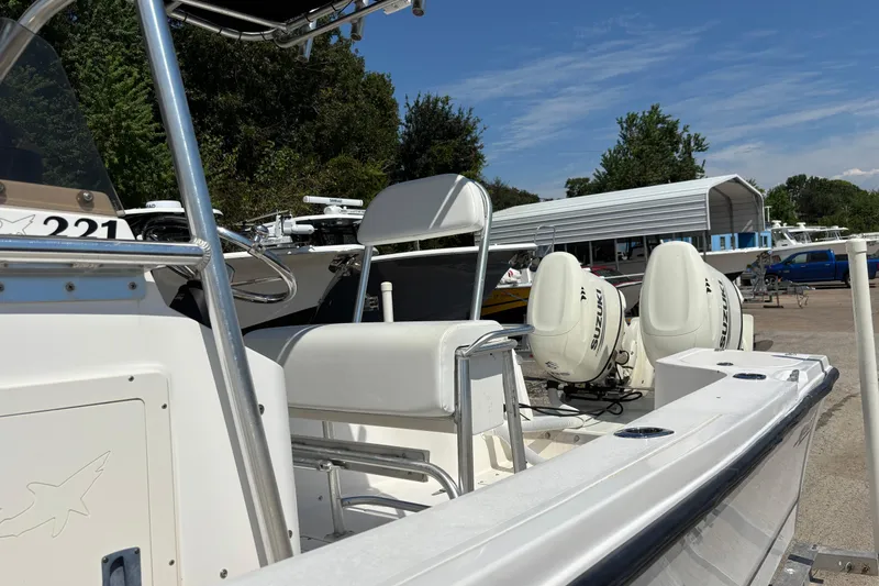 Slide: The Image of 1998 Mako 221 Center Console boat with dual Suzuki outboard motors in a marina setting. - 8