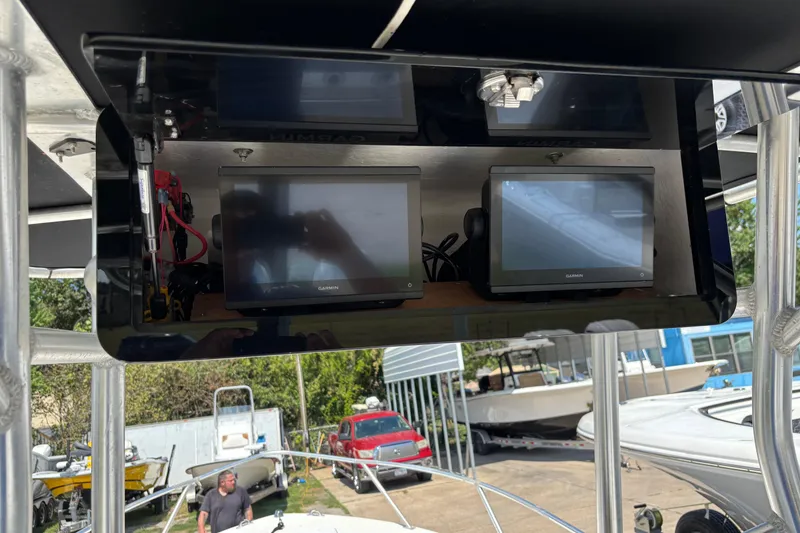 Slide: The Image of 1998 Mako 221 Center Console with Garmin navigation displays and outdoor setting. - 9