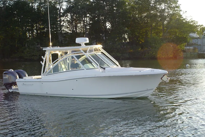 Slide: The Image of 2024 Albemarle 27 Dual Console boat on calm water, side view with Yamaha engine. - 1