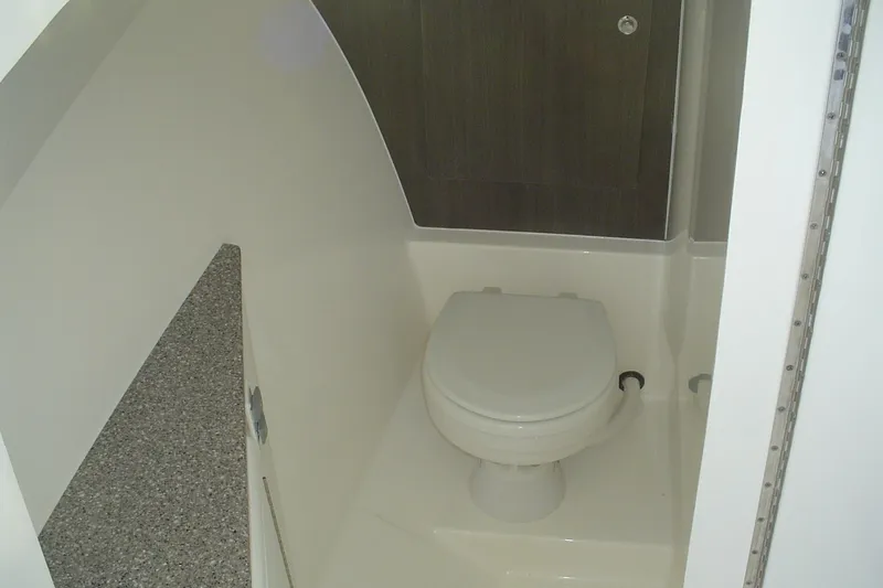 Slide: The Image of 2024 Albemarle 27 Dual Console boat interior bathroom with toilet and countertop. - 29