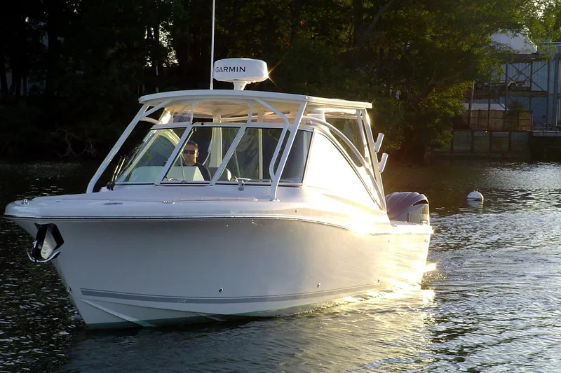 Slide: The Image of 2024 Albemarle 27 Dual Console boat cruising on a serene waterway at sunset. - 3