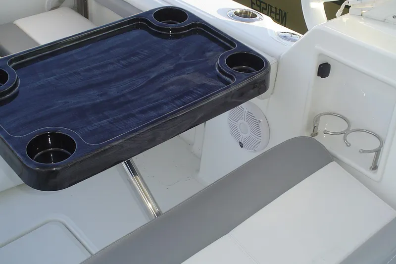 Slide: The Image of 2024 Albemarle 27 Dual Console boat interior with table and cup holders. - 38