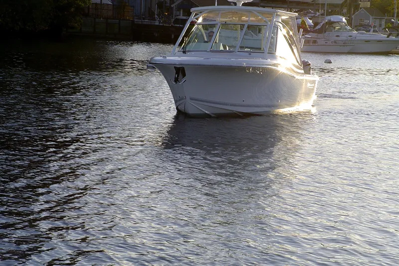 Slide: The Image of 2024 Albemarle 27 Dual Console boat on calm water at sunset. - 4