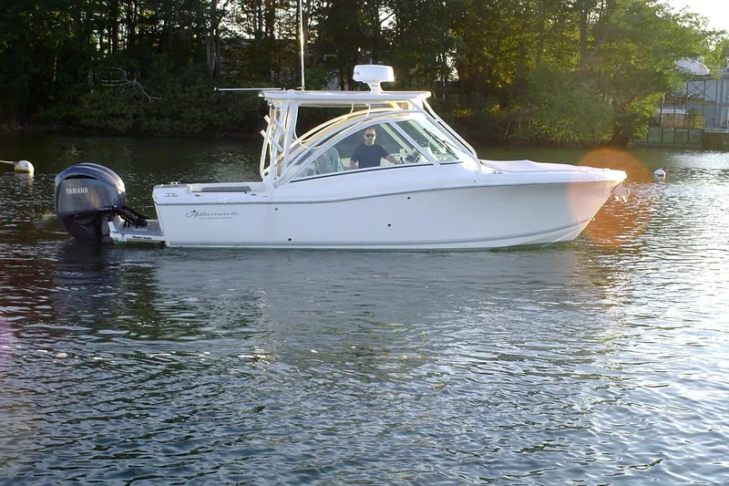 Slide: The Image of 2024 Albemarle 27 Dual Console boat cruising on a calm lake with Yamaha outboard. - 5