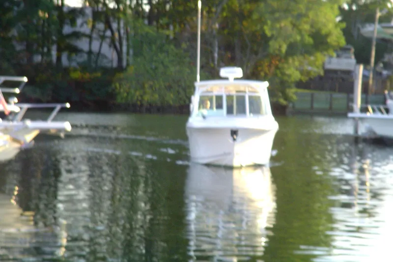 Slide: The Image of 2024 Albemarle 27 Dual Console boat cruising on a calm lake. - 7