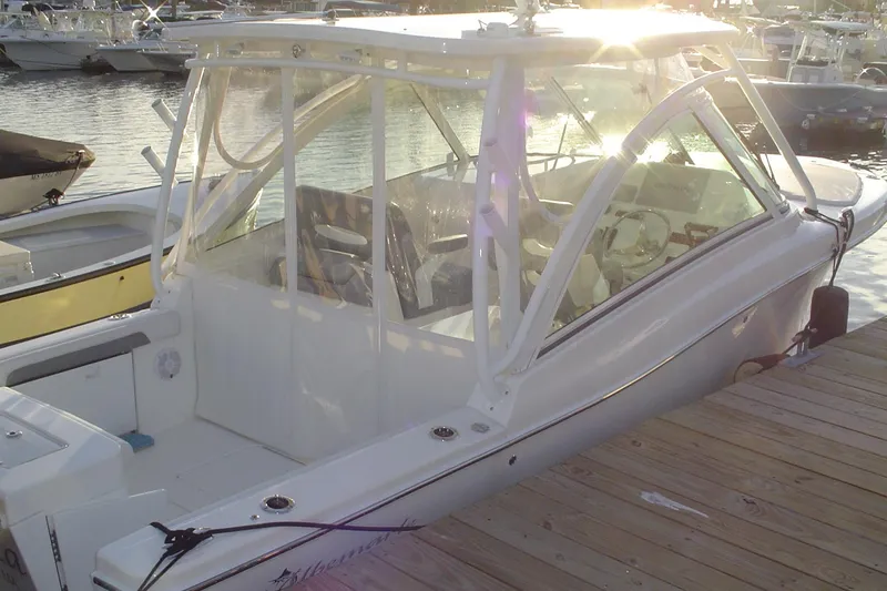 Slide: The Image of 2024 Albemarle 27 Dual Console boat docked at marina, sunlit and sleek design. - 9