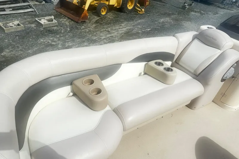 Slide: The Image of 2011 Godfrey Aqua Patio 240 Pontoon boat seating with cup holders, beige and gray upholstery. - 14