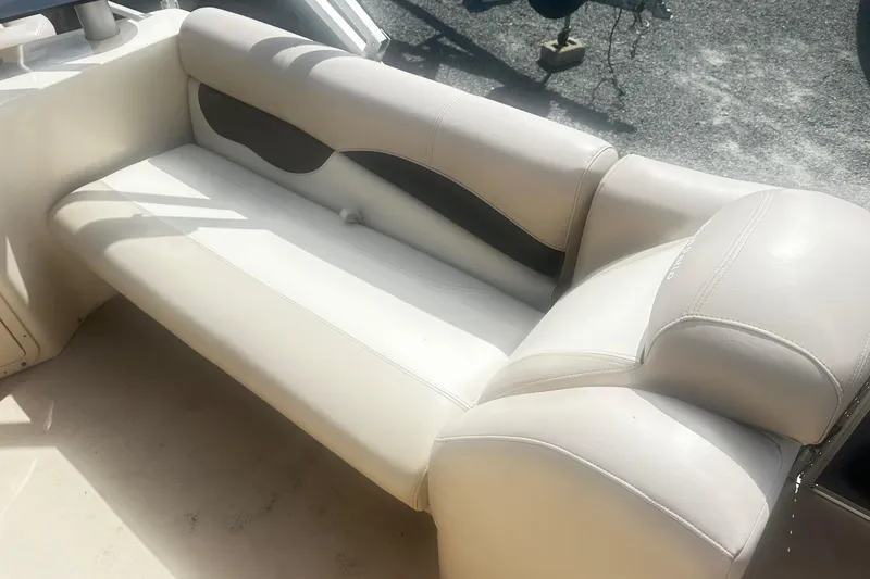 Slide: The Image of 2011 Godfrey Aqua Patio 240 Pontoon boat seat, white and black upholstery, outdoor setting. - 15