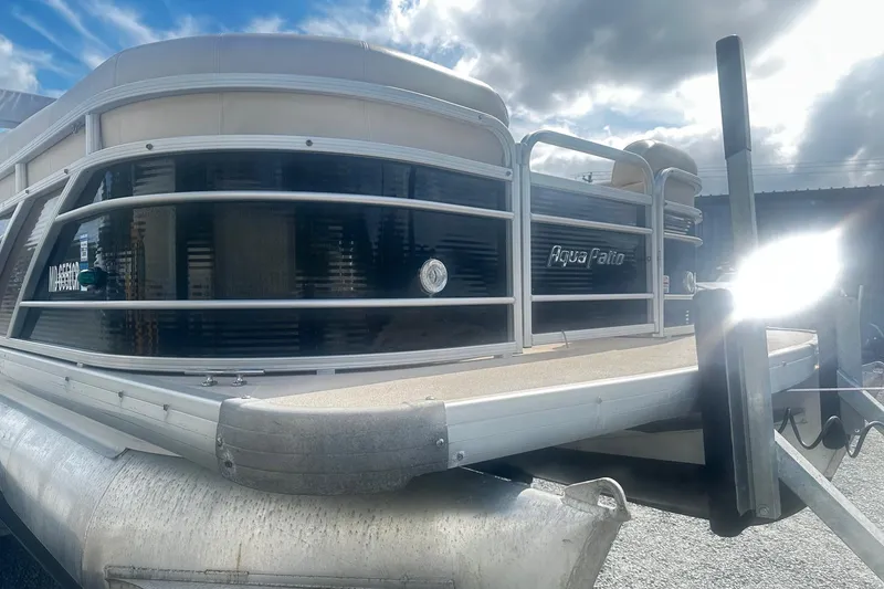 Slide: The Image of 2011 Godfrey Aqua Patio 240 Pontoon boat under a cloudy sky. - 2