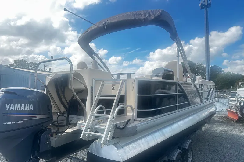 Slide: The Image of 2011 Godfrey Aqua Patio 240 Pontoon with Yamaha engine, parked outdoors under blue sky. - 4