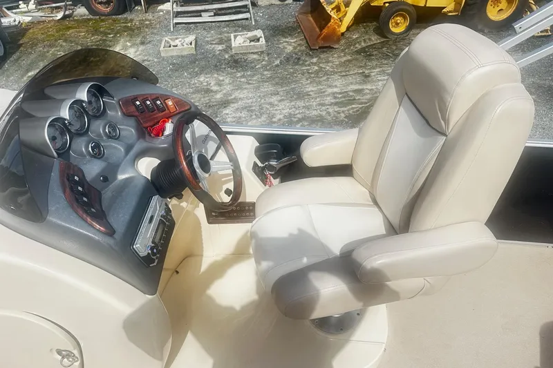 Slide: The Image of 2011 Godfrey Aqua Patio 240 Pontoon boat interior with steering console and captain's chair. - 6