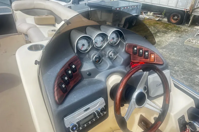 Slide: The Image of 2011 Godfrey Aqua Patio 240 Pontoon dashboard with gauges and controls. - 7