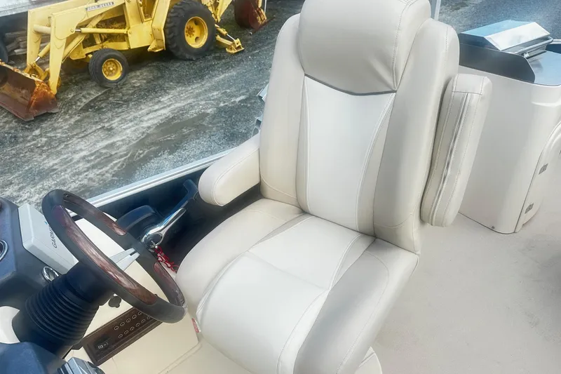 Slide: The Image of Captain's chair on 2011 Godfrey Aqua Patio 240 Pontoon, with steering wheel and controls. - 8