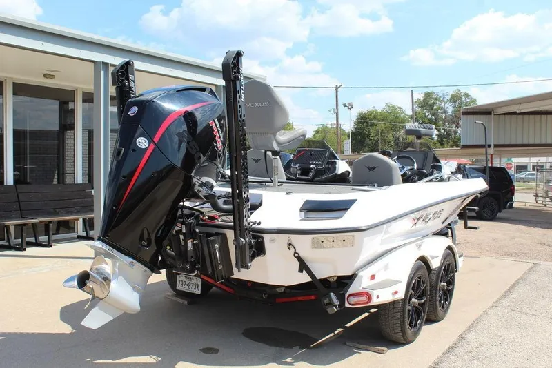 Slide: The Image of 2021 Vexus VX20 boat with powerful outboard motor, parked on a trailer. - 3