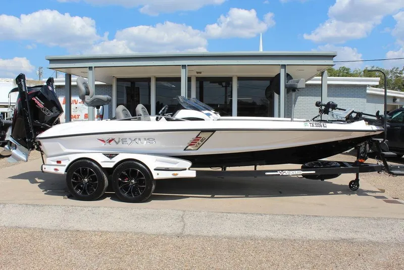 Slide: The Image of 2021 Vexus VX20 boat on trailer, parked outside a building under a clear sky. - 4