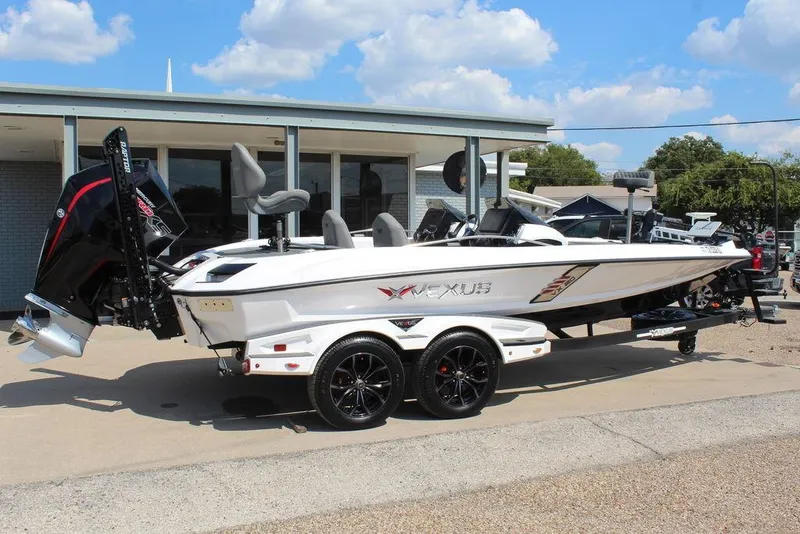 Slide: The Image of 2021 Vexus VX20 boat on trailer, parked outdoors under a clear blue sky. - 6