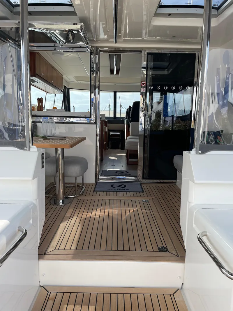 Slide: The Image of Interior view of 2022 Riviera 505 SUV luxury yacht with modern design and wooden flooring. - 12