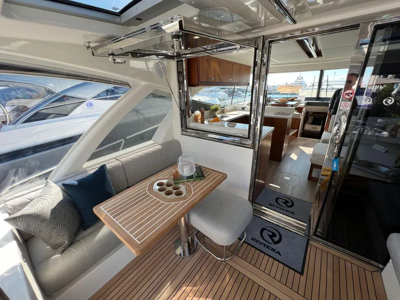 Slide: The Image of Luxurious interior of 2022 Riviera 505 SUV yacht with elegant seating and dining area. - 14