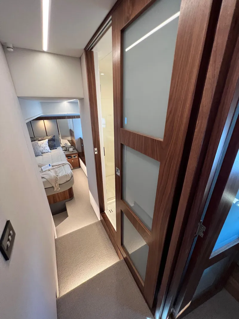 Slide: The Image of 2022 Riviera 505 SUV interior hallway with modern wood paneling and bedroom view. - 34