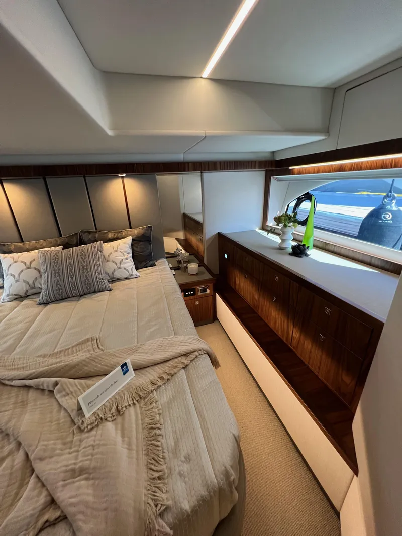 Slide: The Image of Luxurious bedroom interior of 2022 Riviera 505 SUV yacht with elegant decor and ocean view. - 38