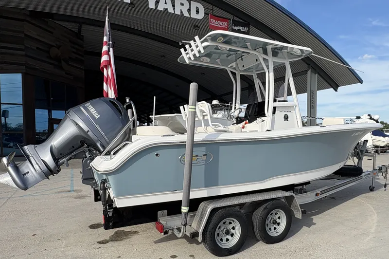 Slide: The Image of 2021 Sea Hunt Ultra 219 boat interior with steering console and rod holders. - 12