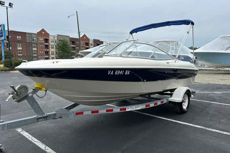Slide: The Image of 2002 Bayliner 195 Capri boat on trailer in parking lot. - 10