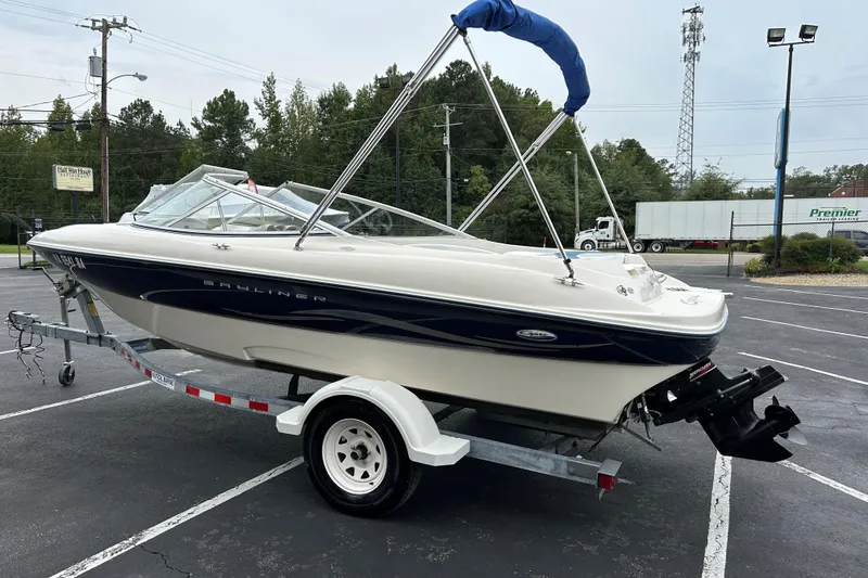 Slide: The Image of 2002 Bayliner 195 Capri boat on trailer in parking lot, overcast day. - 11