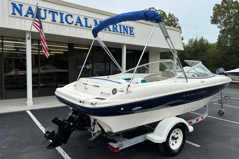 Slide: The Image of 2002 Bayliner 195 Capri boat on trailer outside Nautical Marine store. - 13