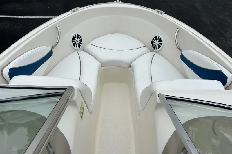Slide: The Image of 2002 Bayliner 195 Capri boat interior with white and blue seating. - 14