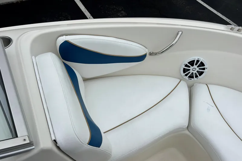 Slide: The Image of Interior seating of a 2002 Bayliner 195 Capri boat with white and blue upholstery. - 15