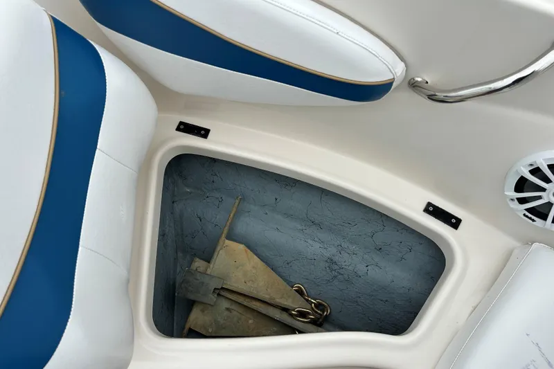 Slide: The Image of Interior of a 2002 Bayliner 195 Capri boat showing storage compartment and seating. - 19