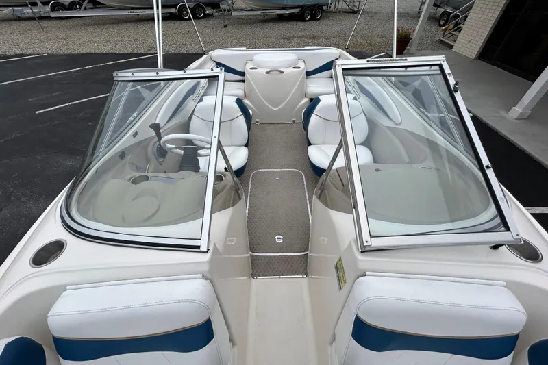 Slide: The Image of 2002 Bayliner 195 Capri boat interior with open windshield and white seating. - 21