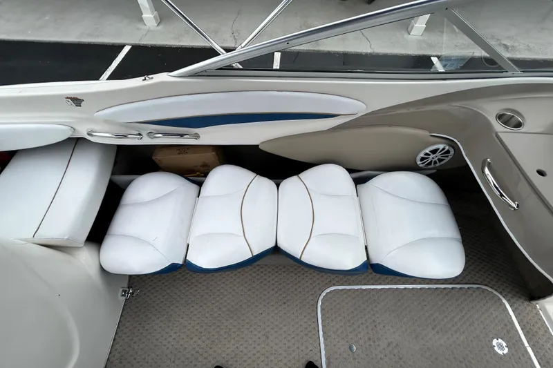 Slide: The Image of 2002 Bayliner 195 Capri interior with white cushioned seats and carpeted floor. - 27