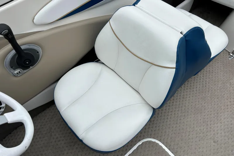 Slide: The Image of White and blue seat in a 2002 Bayliner 195 Capri boat interior. - 31