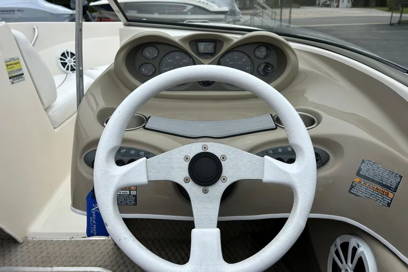 Slide: The Image of 2002 Bayliner 195 Capri boat dashboard with steering wheel and instrument panel. - 34